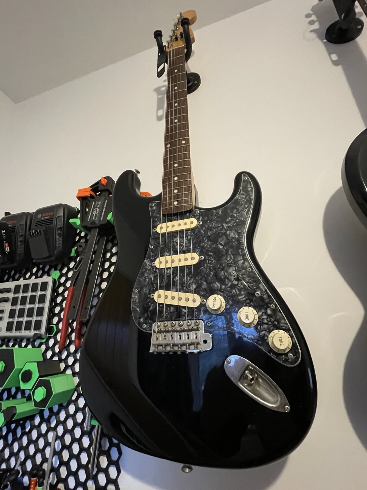 My Fender Stratocaster, hanging on the wall.